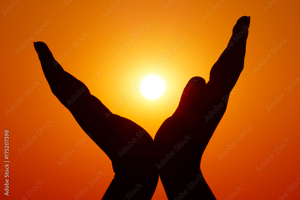 Wings silhouette. Wings gestured with hands. Sunset time on the beach. Freedom sign and symbol. Hands with mehndi.