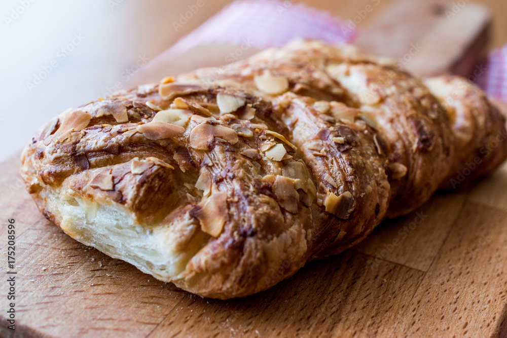Almond Croissant on wooden surface.