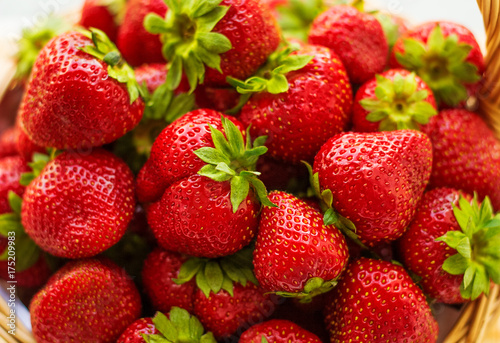 Strawberries in a basket. Garden, vegetable, fruit. Red strawberry on the green background.