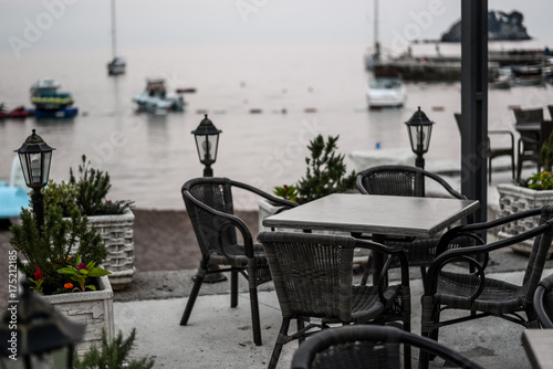 Cafe tables on the quay of Petrovac