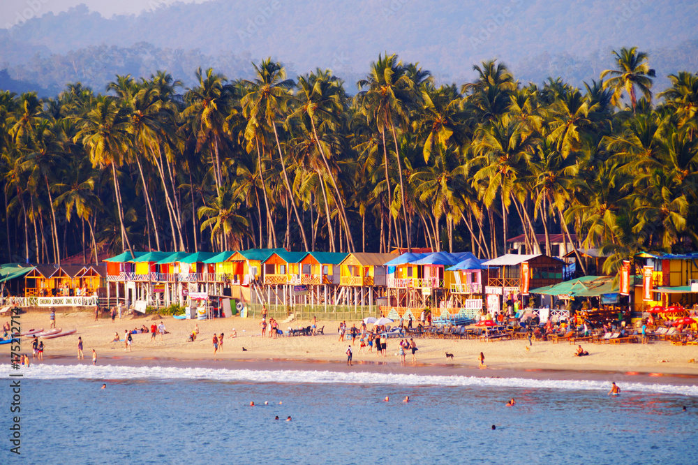 Palolem beach, South Goa, India. One of the best beaches in Goa. Colorful beach huts and palm trees on the coast. Luxury leisure. - obrazy, fototapety, plakaty 