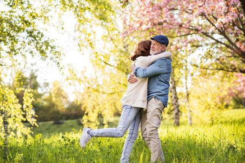 Beautiful senior couple in love outside in spring nature. © Halfpoint