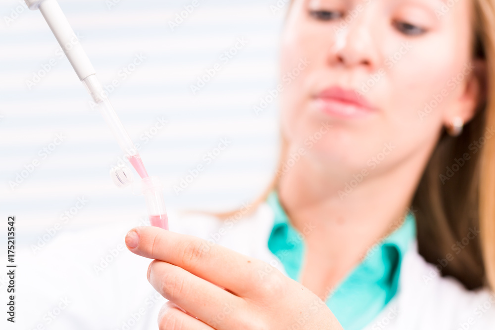 A nurse in a hospital laboratory tests a blood