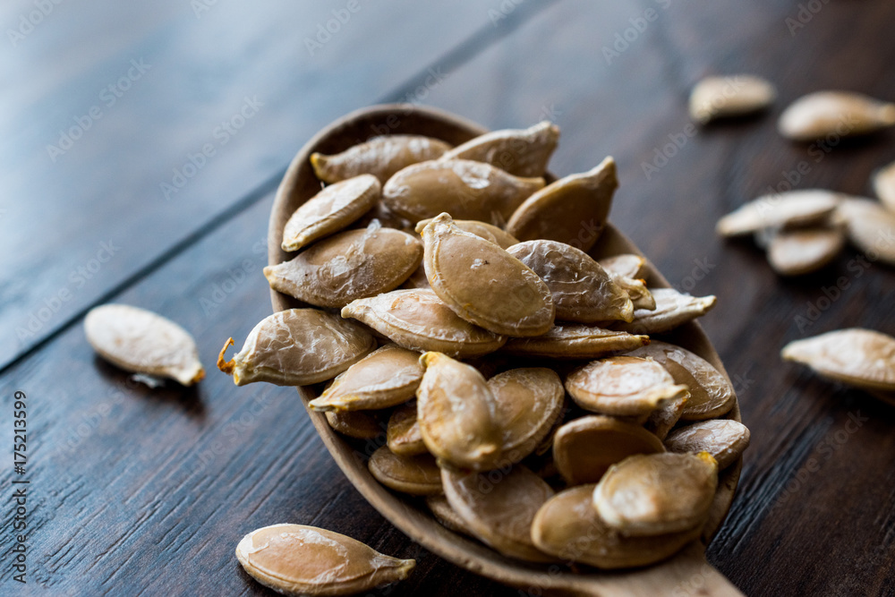 Pumpkin seeds in wooden spoon. Pumpkin seeds in wooden spoon.