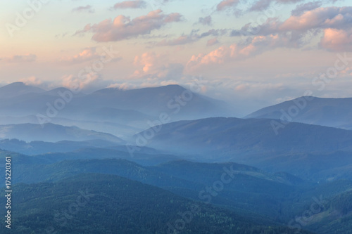 mountain ridges in a blue mist at the evening