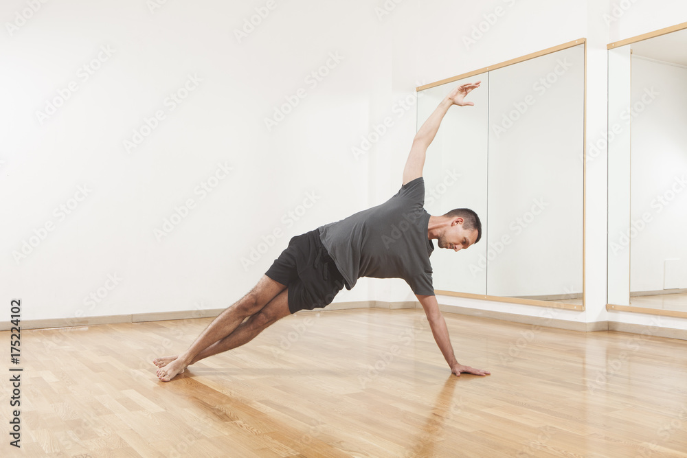 Fototapeta premium Pilates instructor performing fitness exercise at the gym indoor