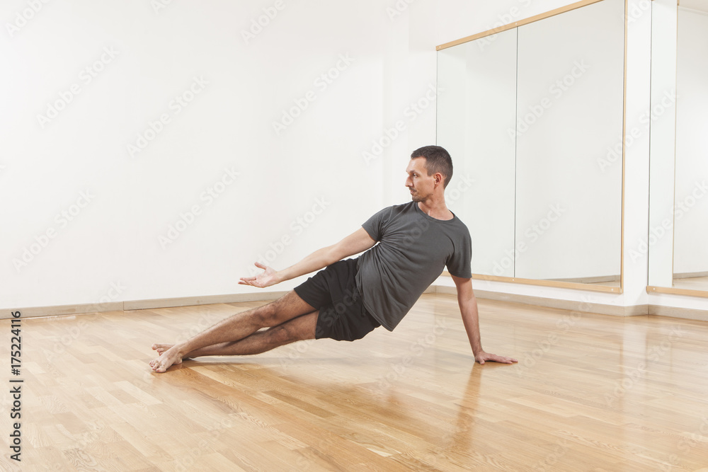 Pilates instructor performing fitness exercise  at the gym indoor