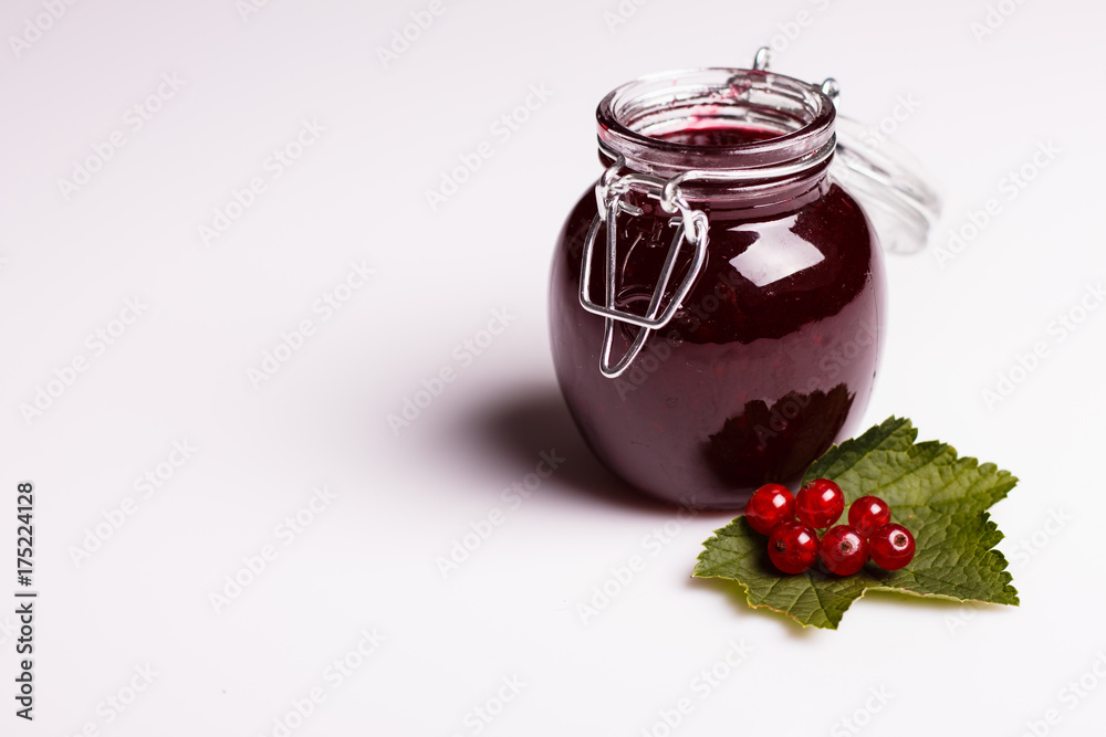 fresh red currants and jam on a white background fresh red currants and jam on a white background