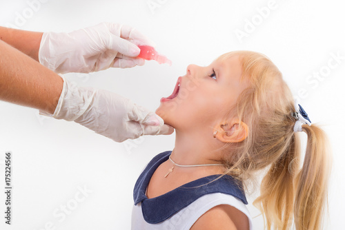 little girl on reception at the doctor receives the polio vaccine, a child being treated for influenza, the child takes the medicine in the hospitalception at the doctor takes antipyretic, 