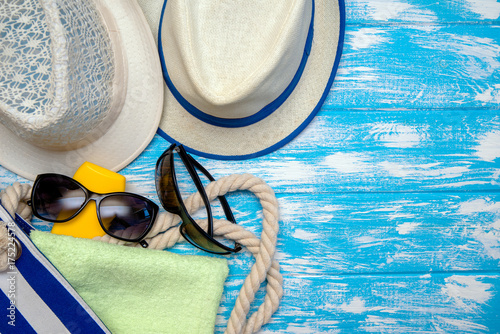 Beach accessories lie on a blue wooden background 