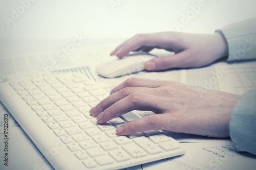 Business woman using computer mouse and keyboard