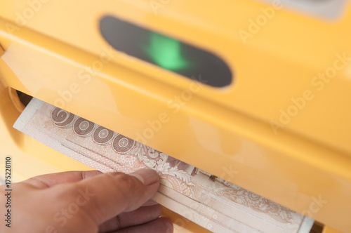 Man hand withdrawing money from atm