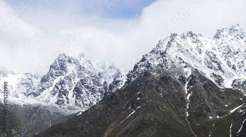 Snow mountain peaks of Caucasus mountains in cold cloudy weather  Elbrus Region. Main caucasian ridge