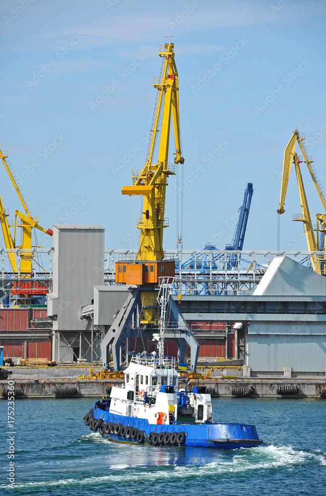 Fototapeta premium Tugboat and port cargo crane