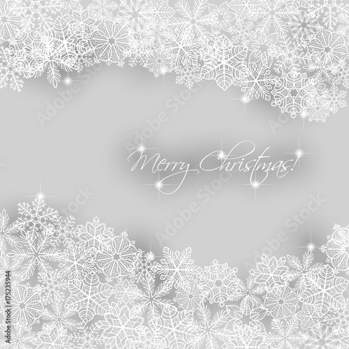 Christmas background. Borders made of fluffy snowflakes with text on soft gray background.