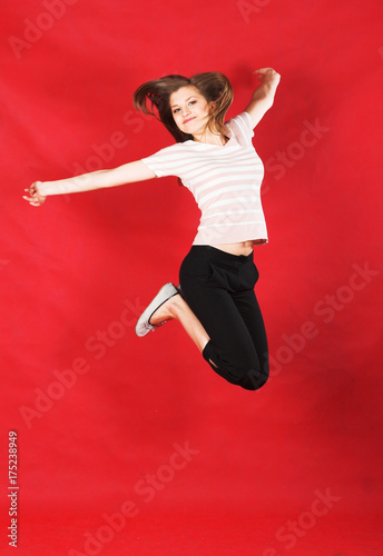 girl jumping of joy over red