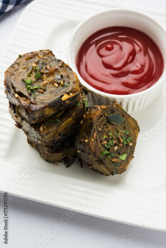 Patra or Paatra or Alu Vadi is a popular maharashtrian and Gujrati snack recipe made using colocasia leaves, rice flour and flavourings spices, tamarind, and jaggery, selective focus

 photo