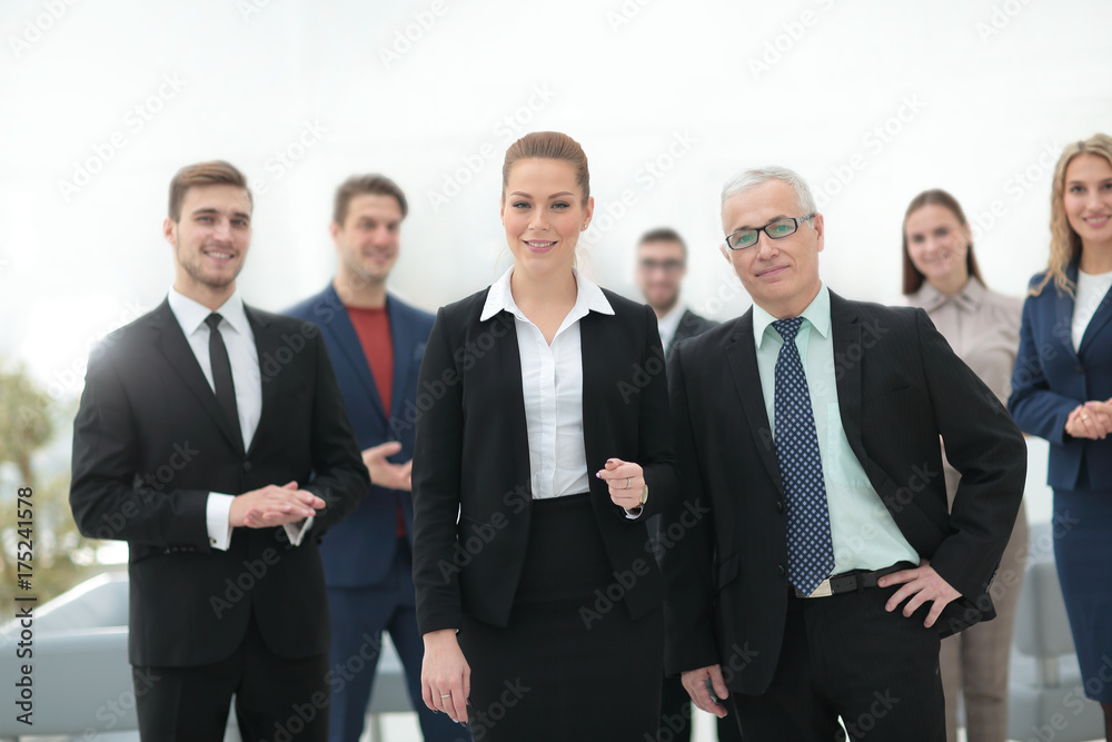 serious businessman and business woman on the background of the office staff. serious businessman and business woman on the background of the office staff.