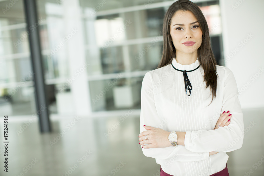 Young businesswoman standing in modern office Young businesswoman standing in modern office
