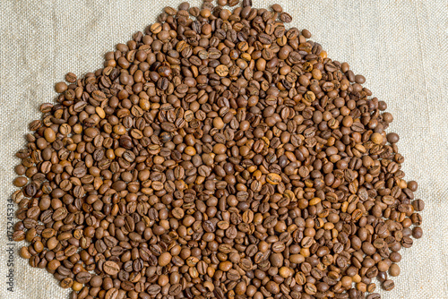 Spilled grains of fragrant coffee close-up.