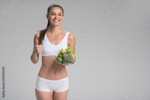 Happy young slim woman keeping on the diet with enjoyment © Yakobchuk Olena