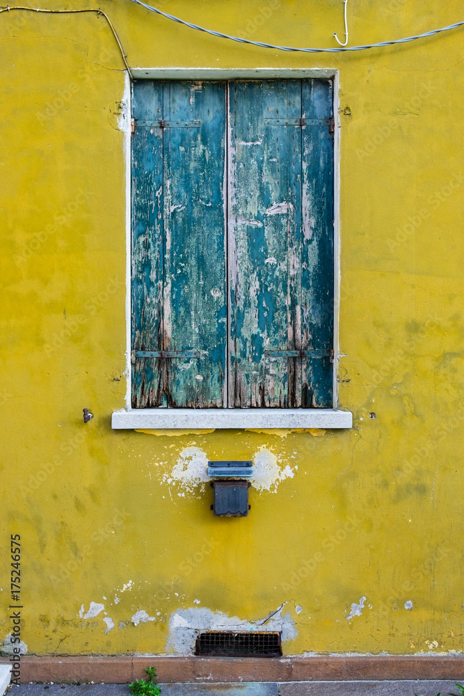 old houses with scraped walls and window