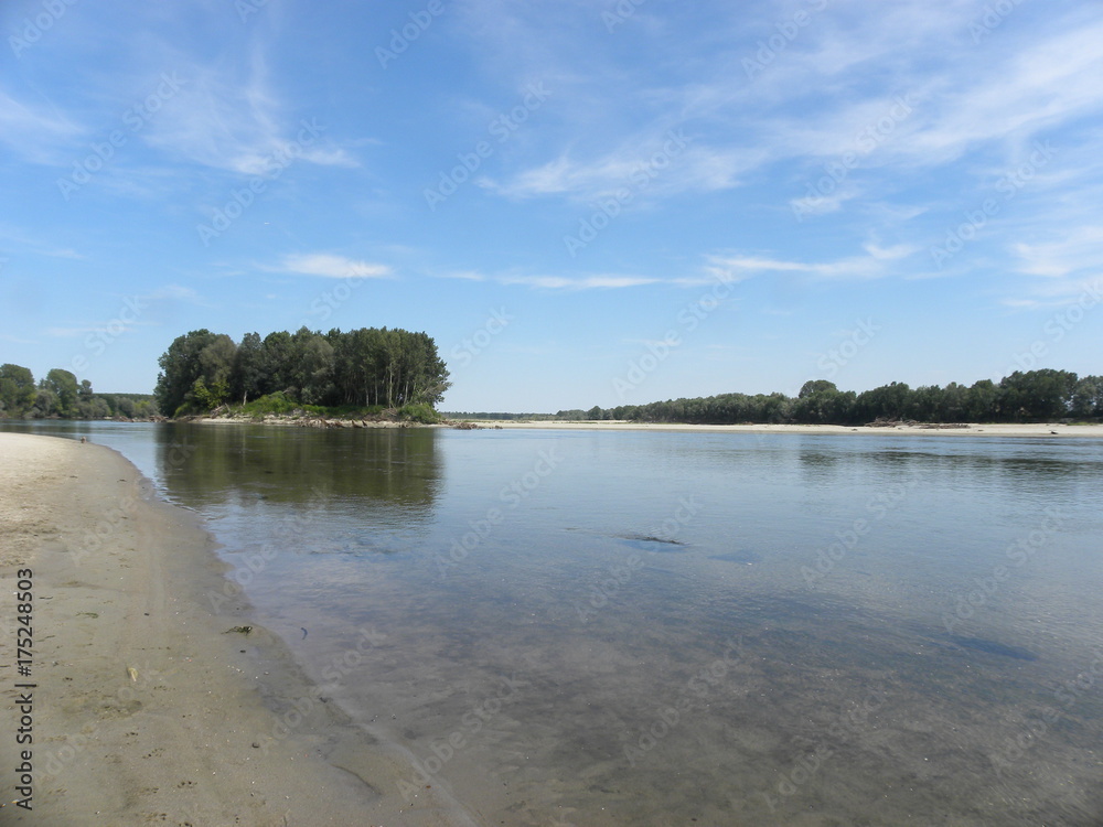 ITALY – JUNE 16, 2017: fluvial landscape at the confluence of Ticino and Po rivers, a few kilometres downstream (along the Ticino) from the city of Pavia, Lombardy. Northern Italy. ITALY – JUNE 16, 2017: fluvial landscape at the confluence of Ticino and Po rivers, a few kilometres downstream (along the Ticino) from the city of Pavia, Lombardy. Northern Italy.