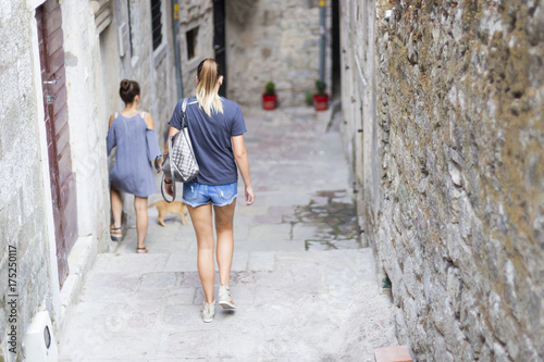 tourists walk along a deserted street