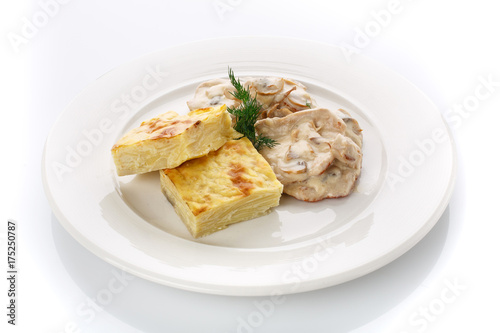 Delicious lunch. Casserole with mushroom sauce on white