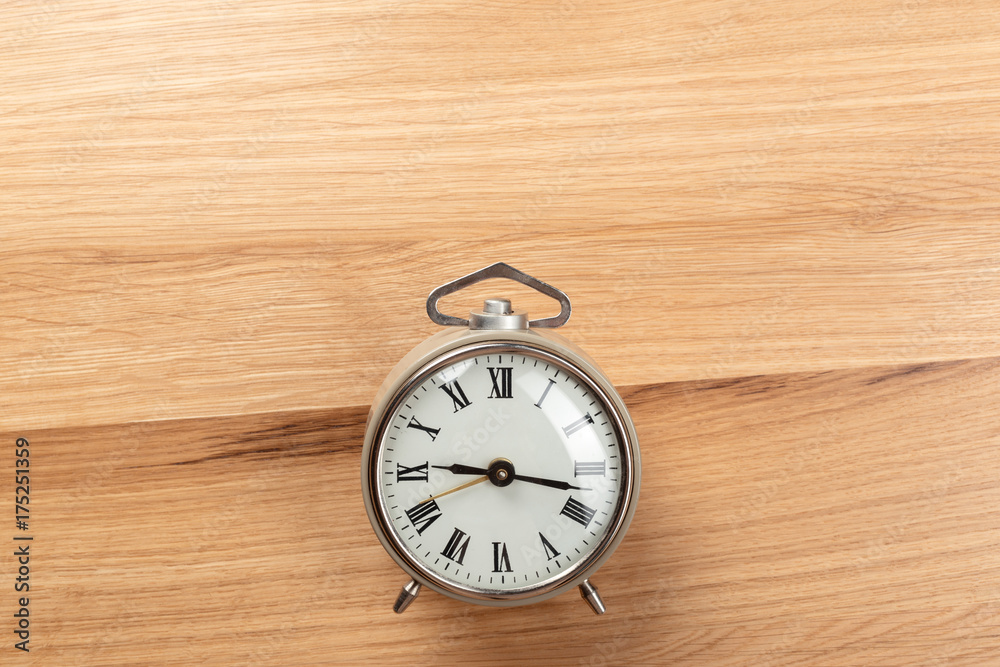 Alarm clock on wooden table Alarm clock on wooden table