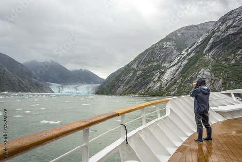 Cruise ship visitor taking photo of a big glacier in Glacier bay national park, Alaska