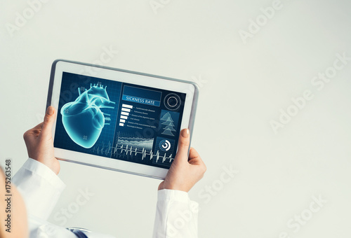 Close of female doctor hands working with tablet pc computer