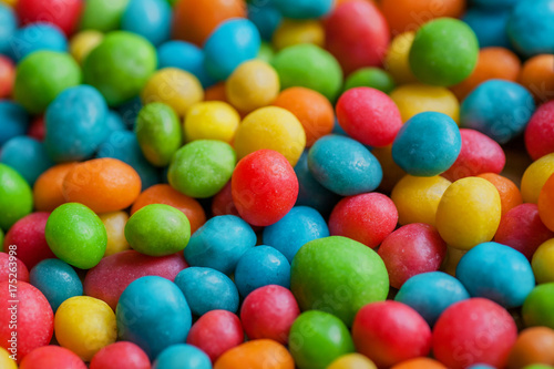 Sugar candy sweet background. Confections in green, yellow, red color drops. Bright texture and round forms of raisins or nuts