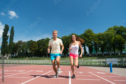 Couple running on arena track