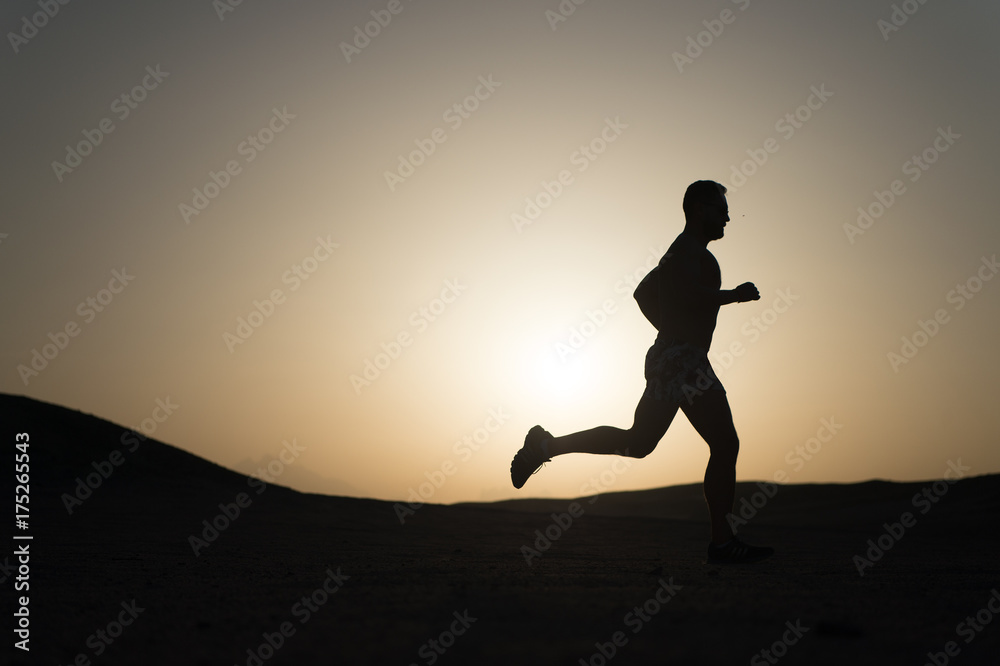 Fototapeta premium running man on mountain nature landscape on sky background