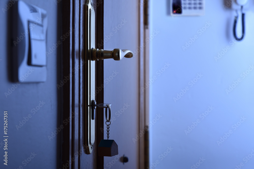 Door with keys in the lock security night concept Door with keys in the lock security night concept