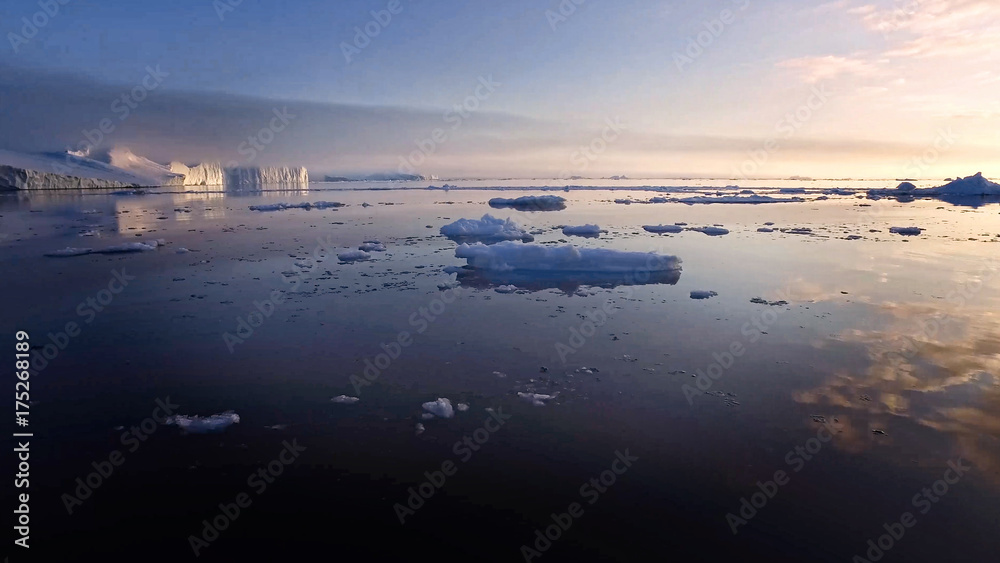Fototapeta premium Arctic Icebergs Greenland in the arctic sea. You can easily see that iceberg is over the water surface, and below the water surface.