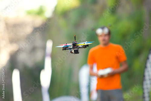 Quadrocopter in flight. Copter is operated by a young pilot