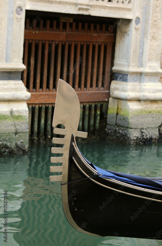 bow of the gondola with the famous metal symbol in venice during bow of the gondola with the famous metal symbol in venice during