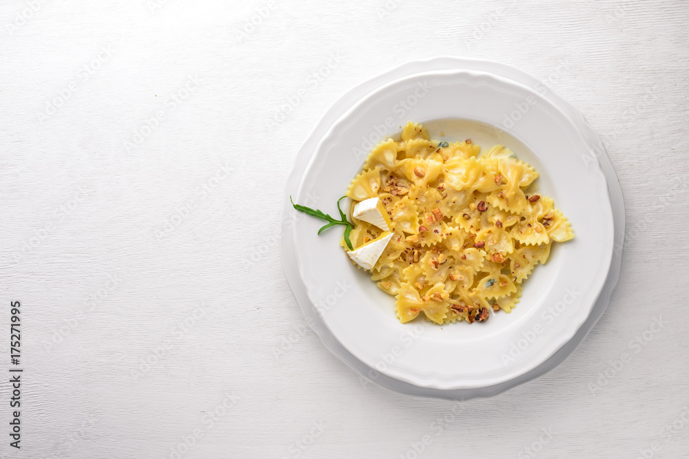 Pasta four cheeses. Italian food. On a wooden background. Top view. Free space for text. Pasta four cheeses. Italian food. On a wooden background. Top view. Free space for text.