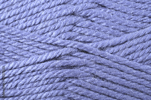 A super close up image of violet yarn