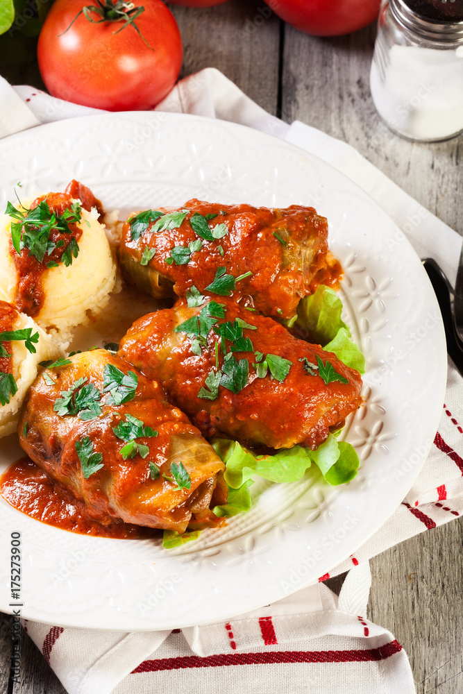 Stuffed cabbage with meat and rice served with boiled potatoes and tomato sauce Stuffed cabbage with meat and rice served with boiled potatoes and tomato sauce