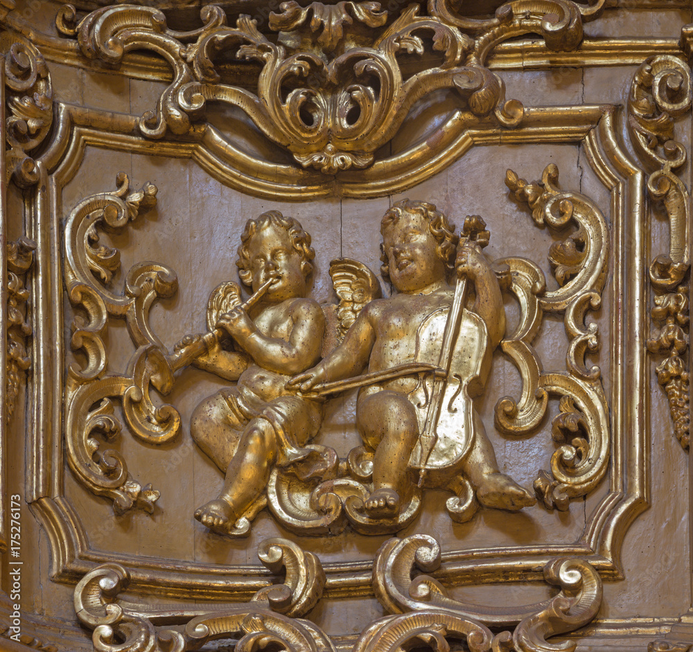 TURIN, ITALY - MARCH 13, 2017: The polychrome carved baroque relief of angels in church Chiesa di San Giuseppe by unknown artist.