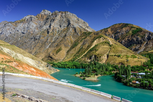 Panoramic view of Charvak Lake, a huge artificial lake-reservoir with azure water created by erecting a high stone dam on the Chirchiq River, located in Tashkent region of Uzbekistan