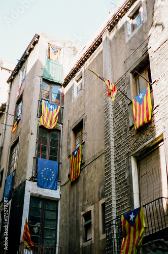 Estelada and European flags hanging from balconies in Barcelona photo