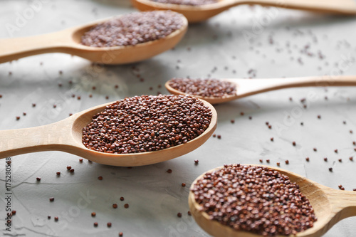Spoons with quinoa seeds on table