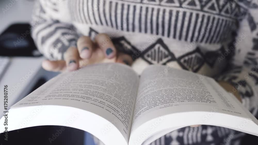 Close up of a Bible being read by a girl. The pages are turned one by one