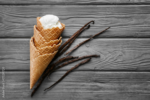 Waffle cones with vanilla ice cream on wooden table © Africa Studio