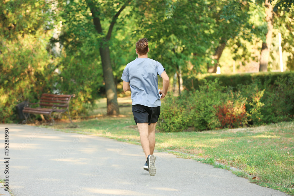 Sporty young man running outdoors