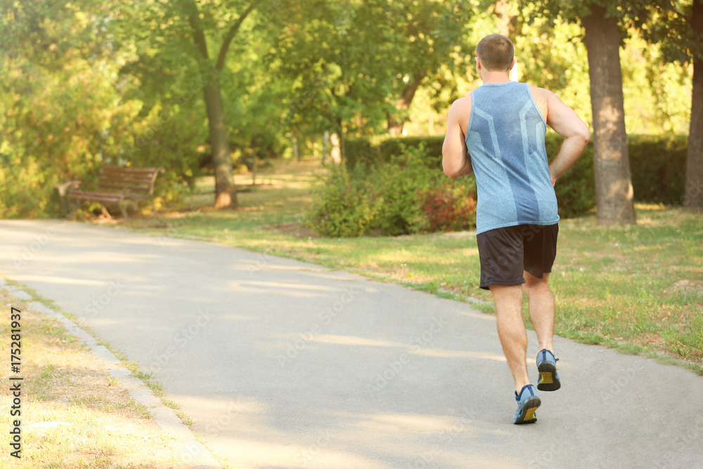 Sporty young man running outdoors